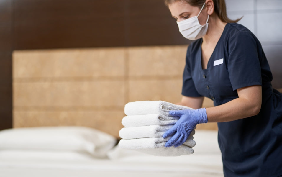 Women Hotel Staff Keeping Hotel With Guest towels