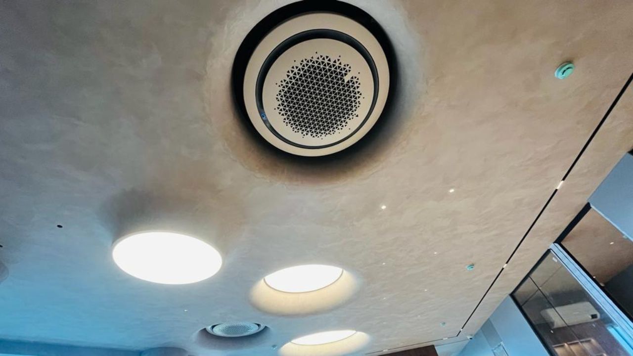 white 360 round cassette ac installed in office room